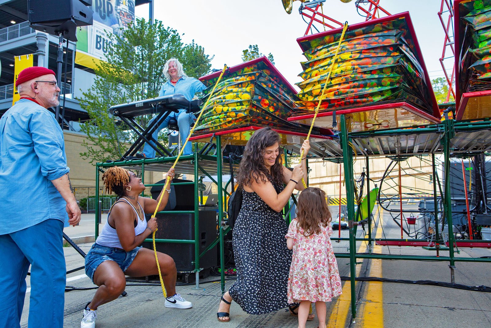 People play the Squonkcordion at a performance of "Brouhaha."