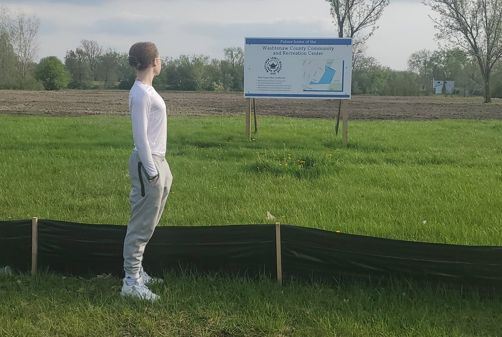Author Jahshua Treadwell stands at the site of a future community center in Superior Township.