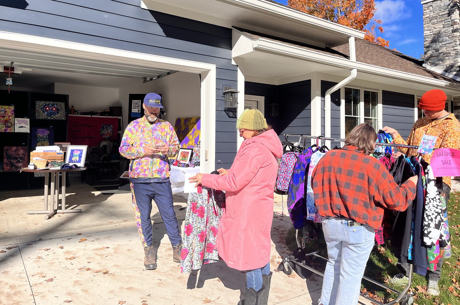 Artist Aaron Hillebrand, known as Dirtbags and Champagne, vends out of a driveway at Westside Art Hop.