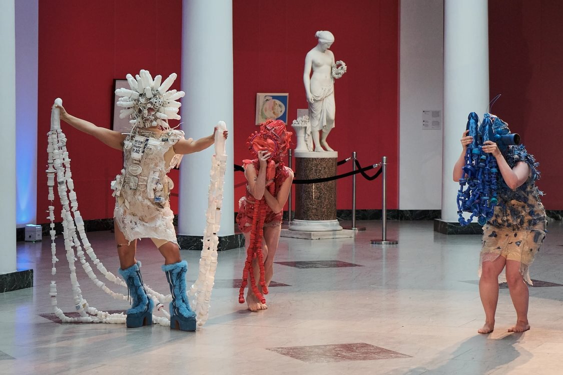 Performers wear costumes created by Machine Dazzle in a runway-style show at UMMA.