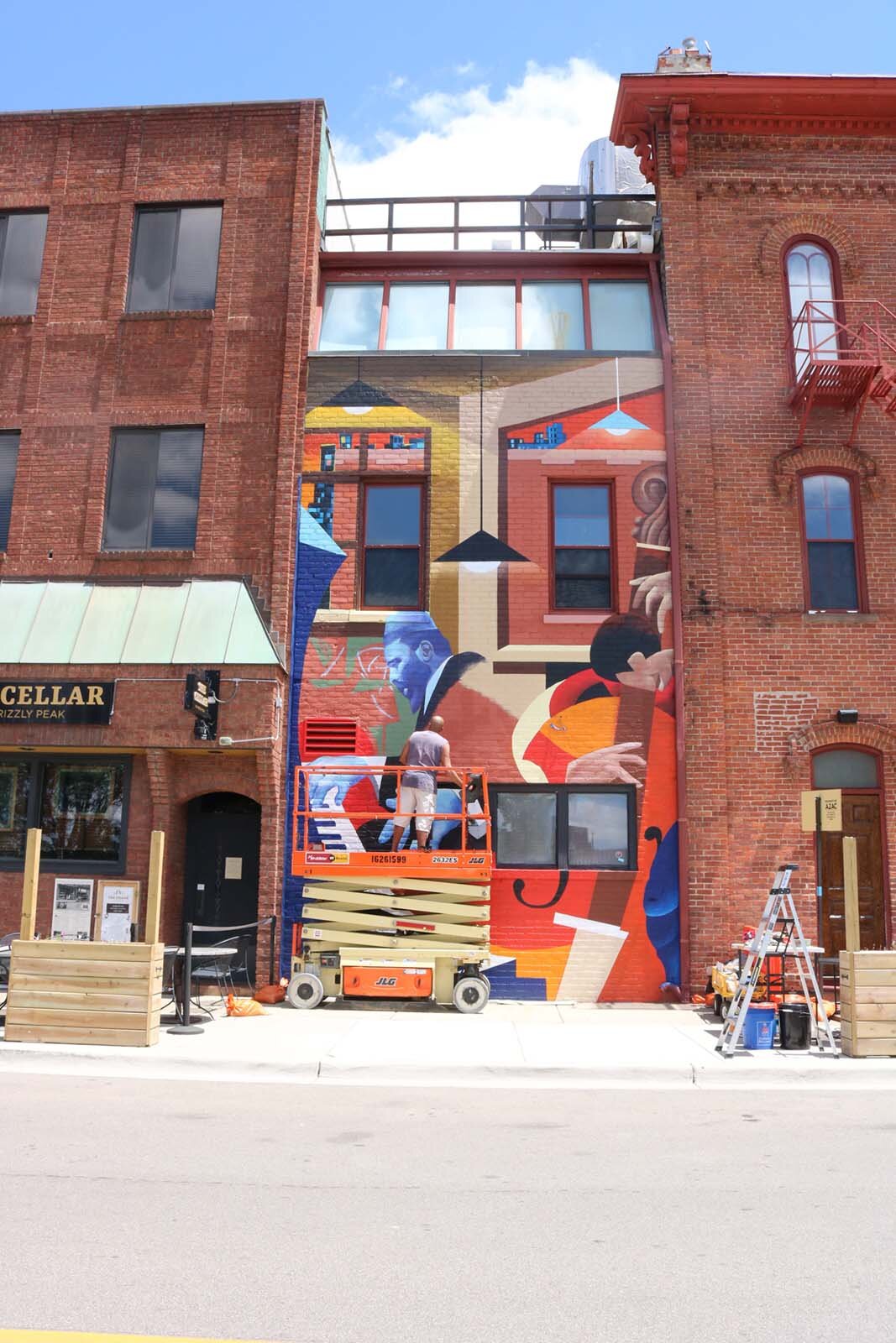 Brian Whitfield works on the mural at 122 W. Washington St. in Ann Arbor.