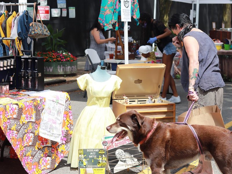 A customer browses a pop-up market hosted by The Back Office Studio.