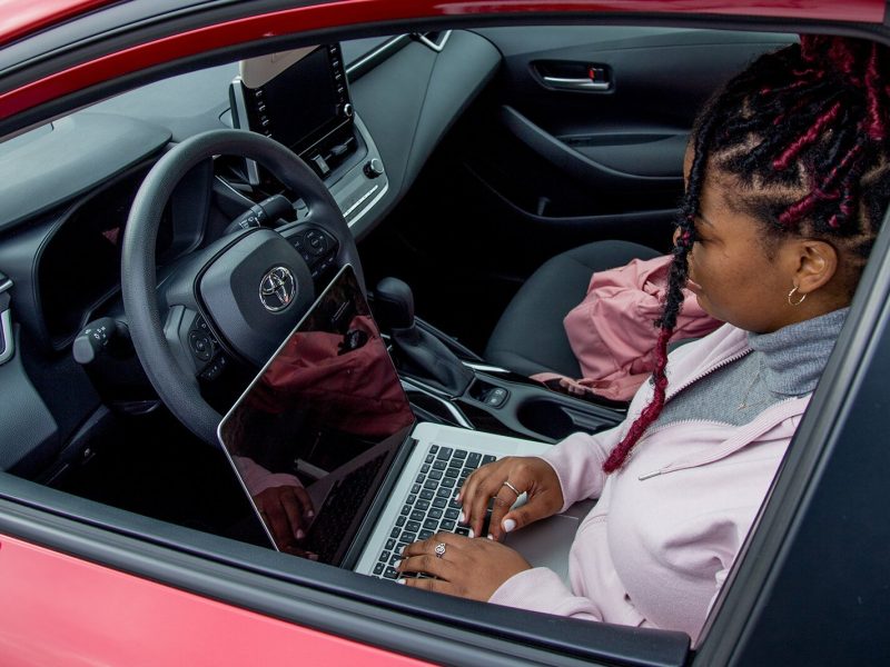 A woman works on a laptop in her car at Ypsilanti Community Middle School, where a new public Wi-Fi hotspot will be located.