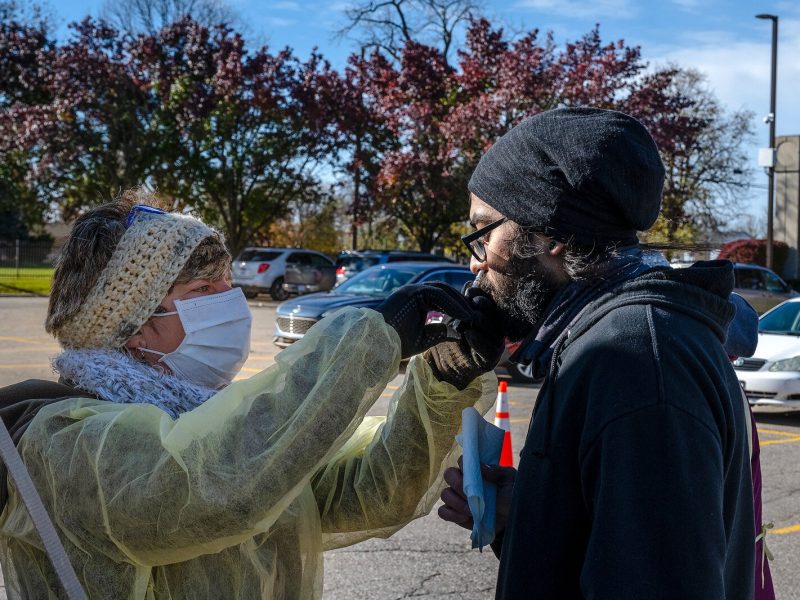 A nasal flu vaccine is administered in the Washtenaw County Health Department parking lot in Ypsilanti.