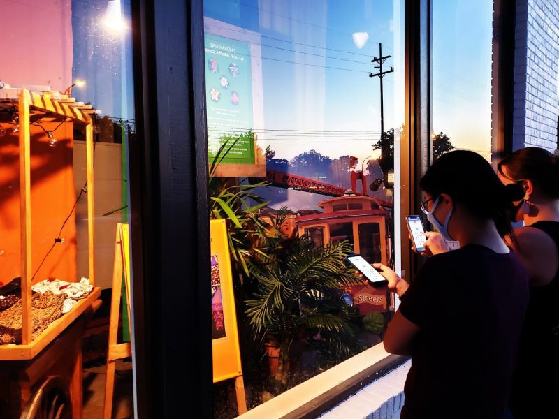 The game "Around the World in 30 Minutes" can be played outside Decode Ann Arbor's location by solving challenges on a smartphone.