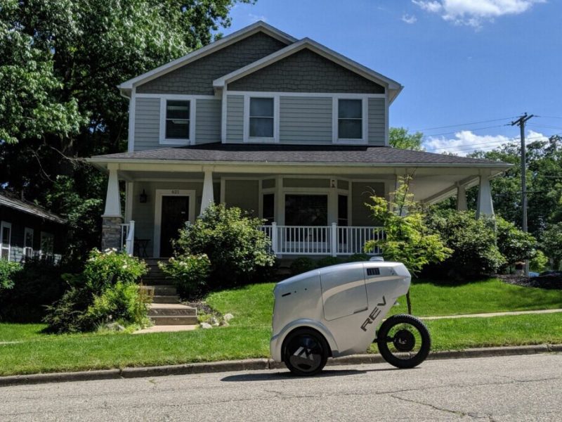 A Refraction AI REV-1 robot makes a delivery.