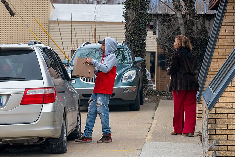 Patrick Cheatham and Khadija Wallace hand out meals at Joyful Treats Community Development.