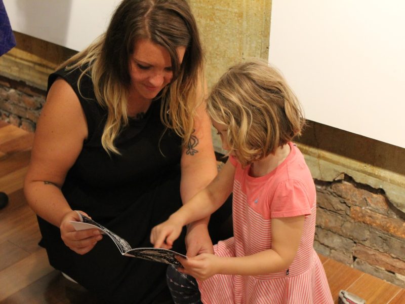 Artist Corryn Jackson looking at zines with a 2015 Zine Show attendee.
