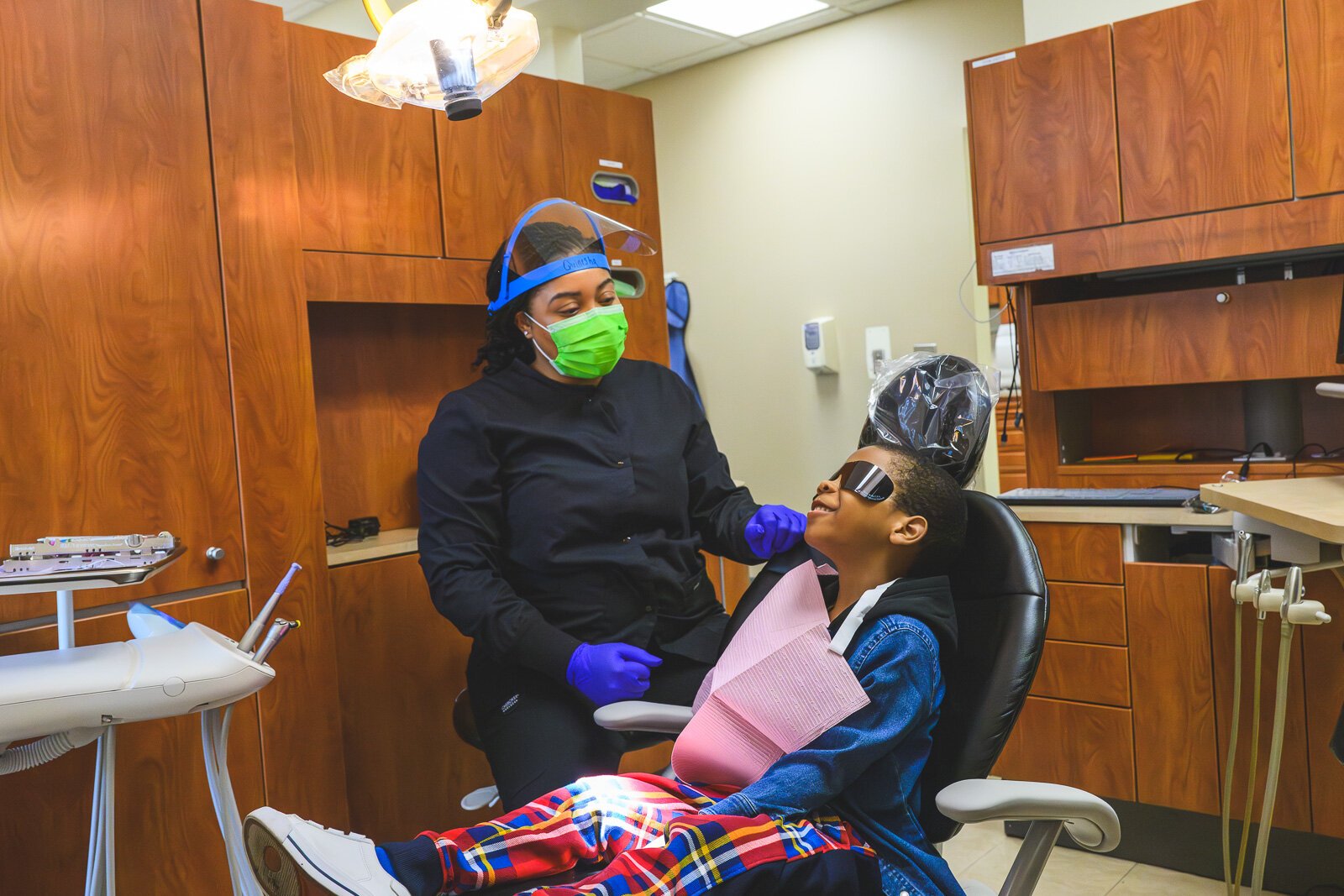 Dental hygienist Quinesha Brewer lets Giovanni know what to expect.