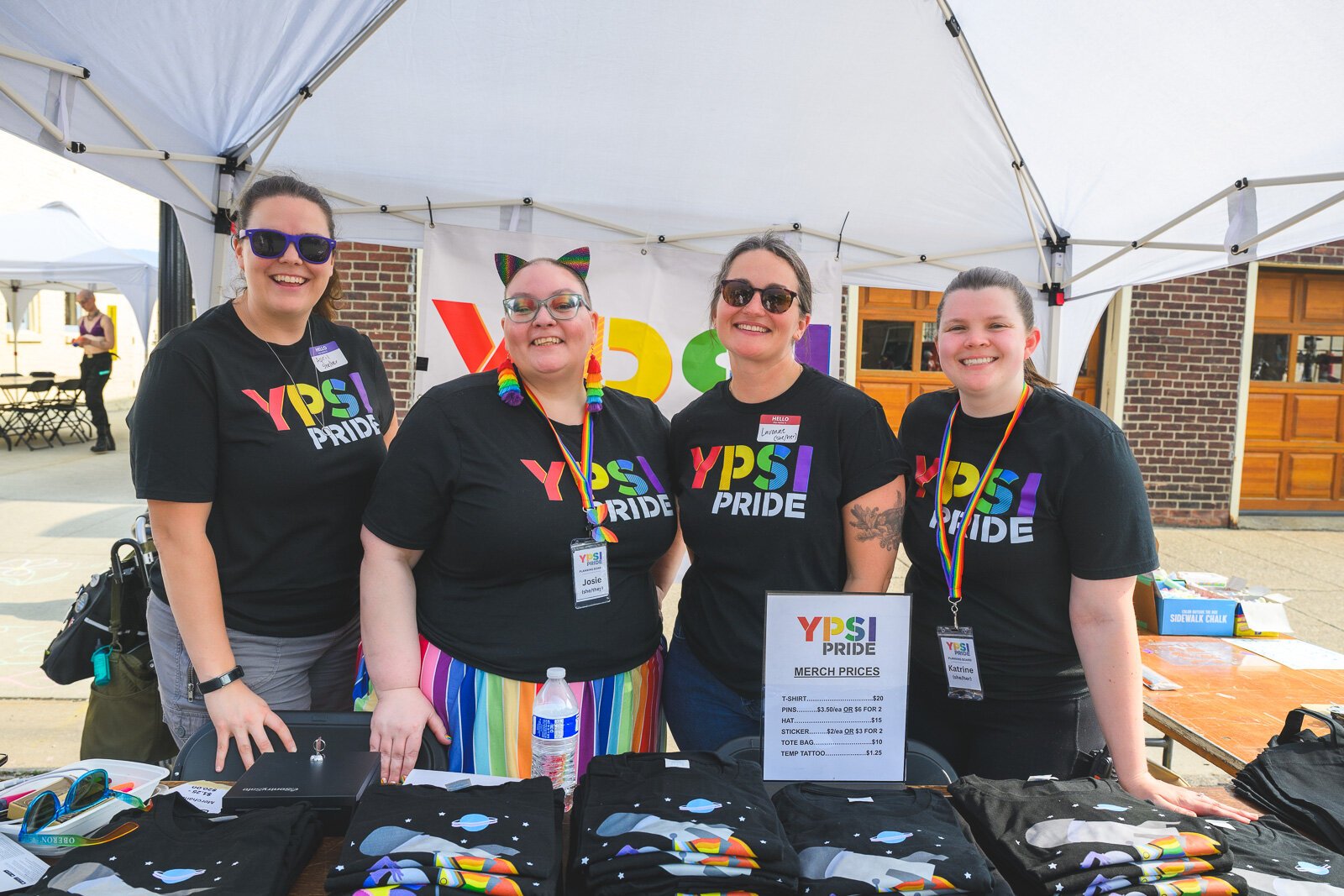 2025 Ypsi Pride staff members selling merch at the Ypsi Pride tent.