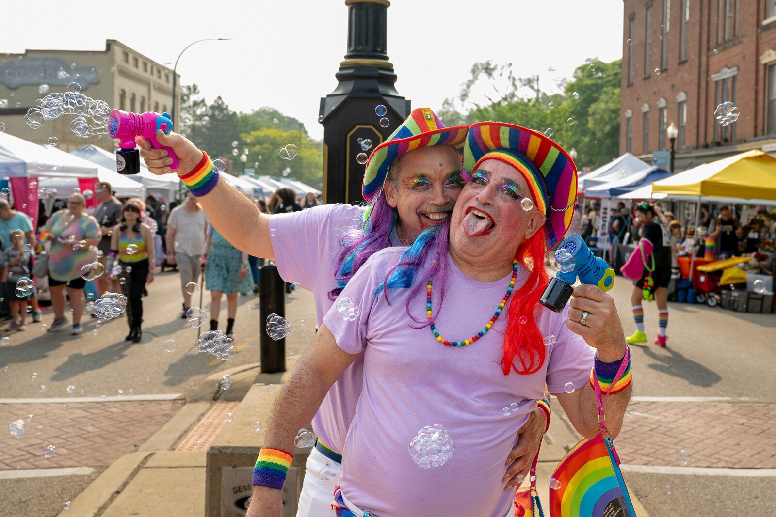 Two 2025 Ypsi Pride attendees showering the crowd with bubbles.