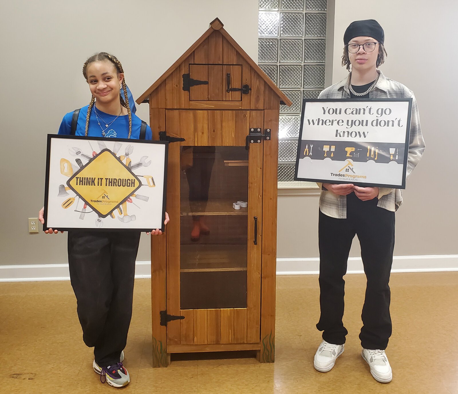 TradeScouts program participants pose with small sheds they built to be used as Little Free Libraries and mini-food pantries.