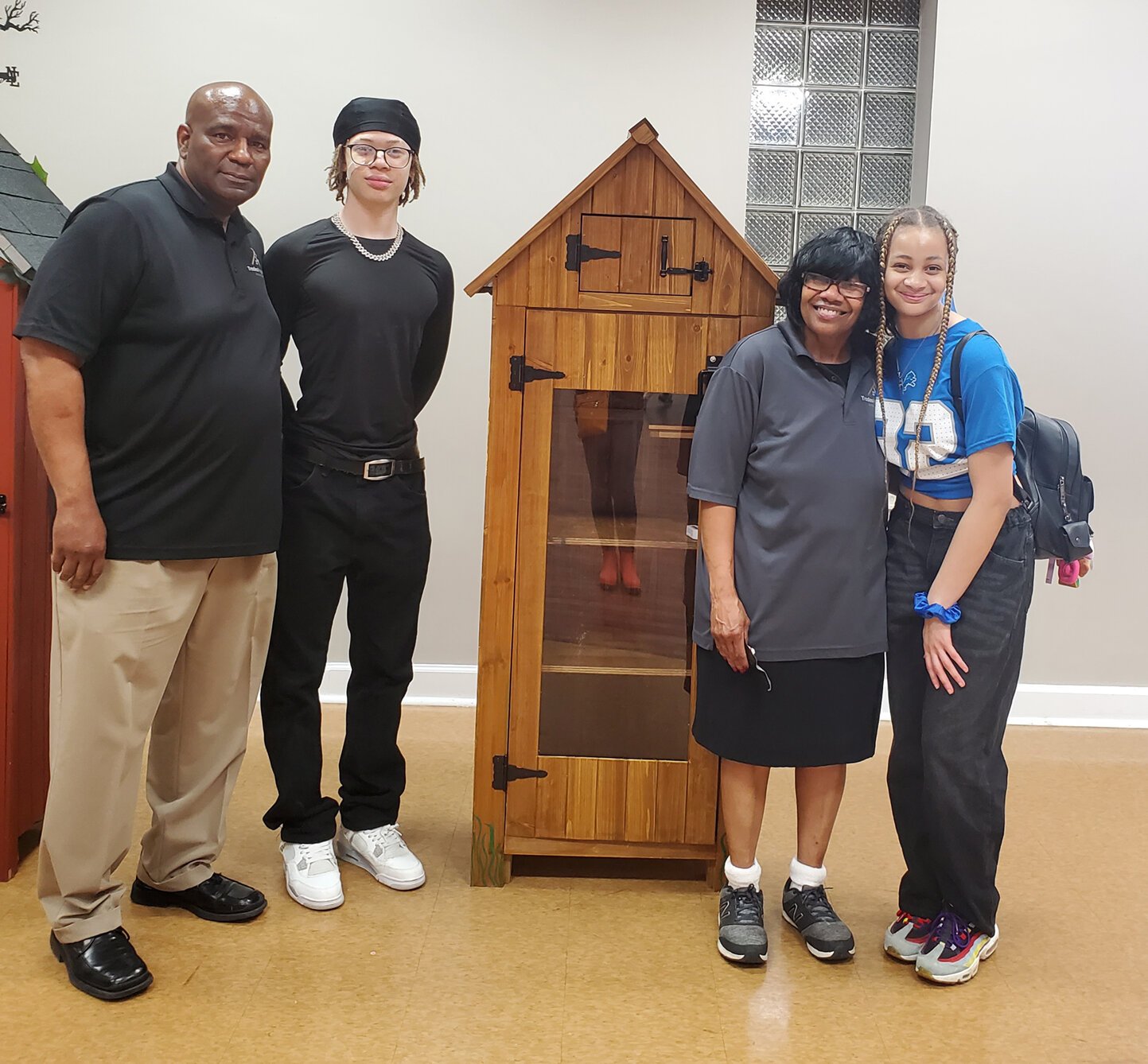 TradeScouts program participants and leaders pose with small sheds they built to be used as Little Free Libraries and mini-food pantries.