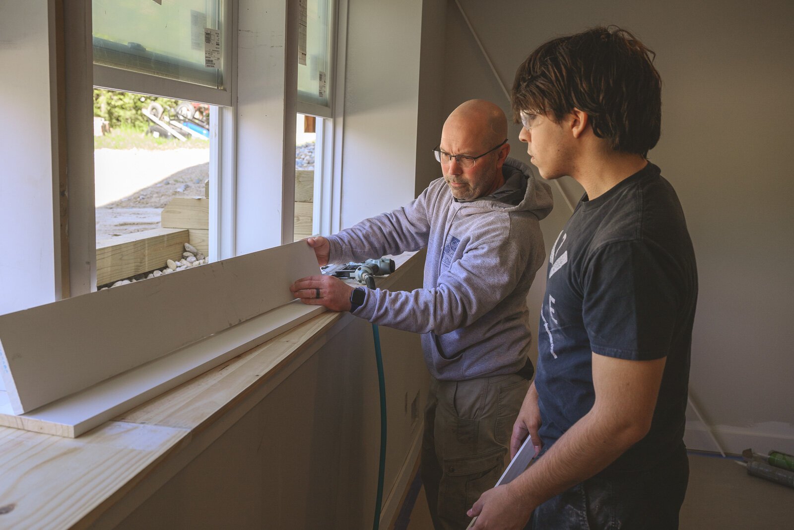 Homebuilding instructor Mark Valchine works with student Nick Turenne.