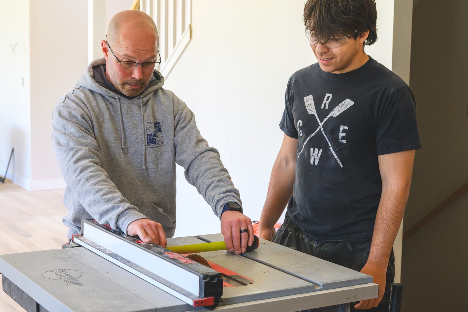 Homebuilding instructor Mark Valchine works with student Nick Turenne.