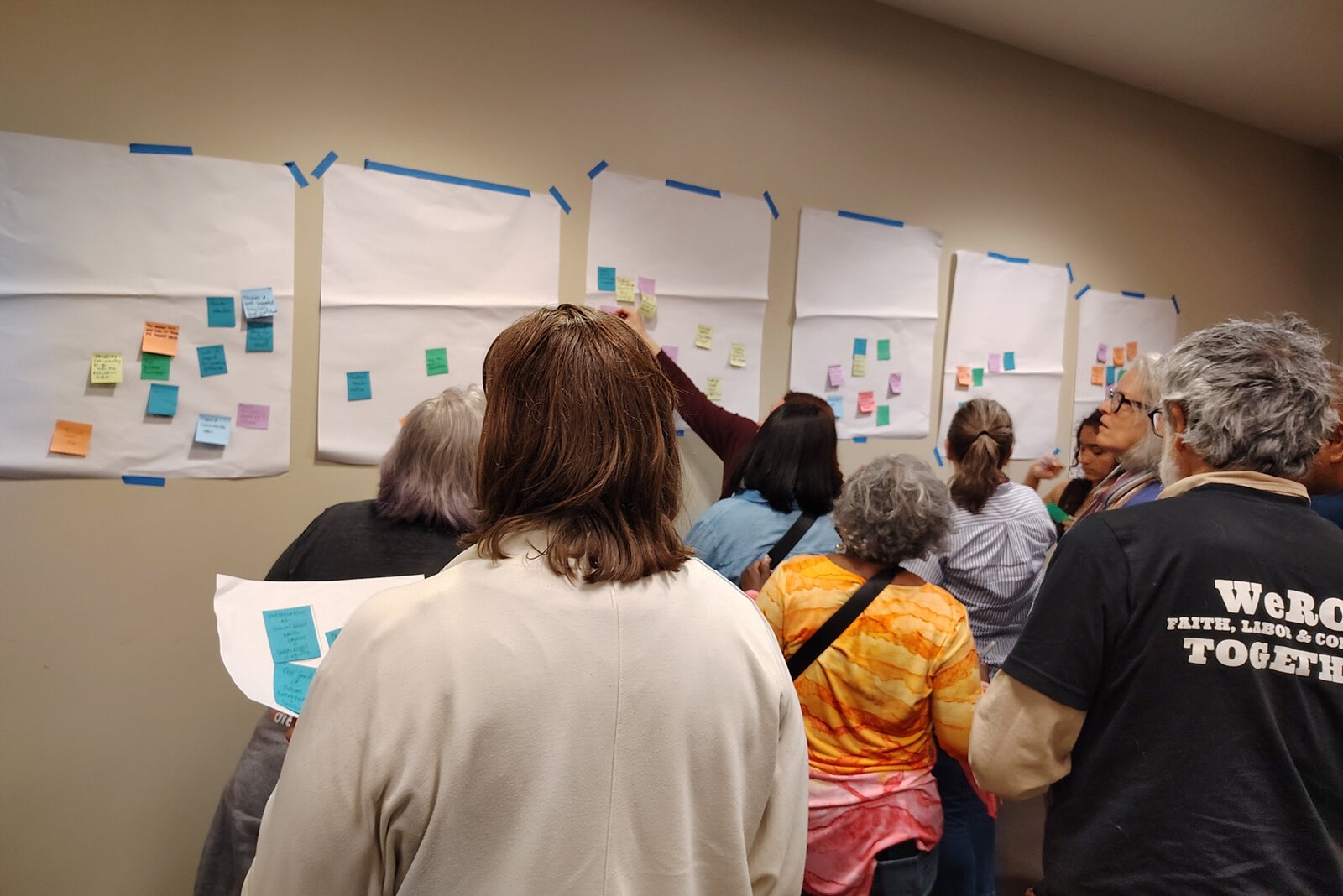 At an April 21 meeting at Eastern Michigan University, attendees wrote concerns about the future of school funding on sticky notes, grouping similar concerns together.