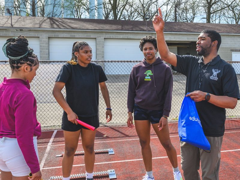 Sean Brandon Jr. coaching All About Speed Track Club members at the YCHS track.