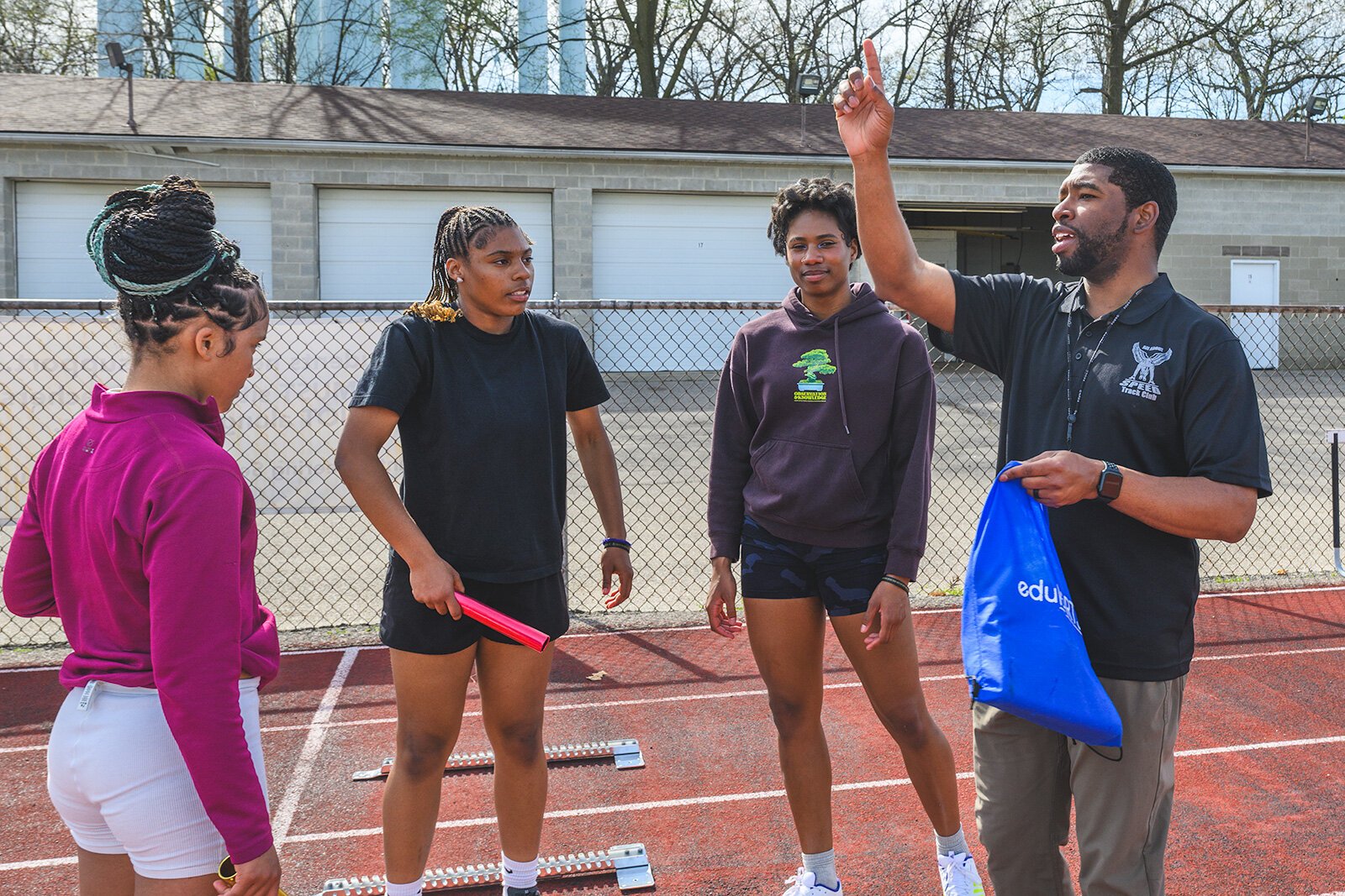 Sean Brandon Jr. coaching All About Speed Track Club members at the YCHS track.