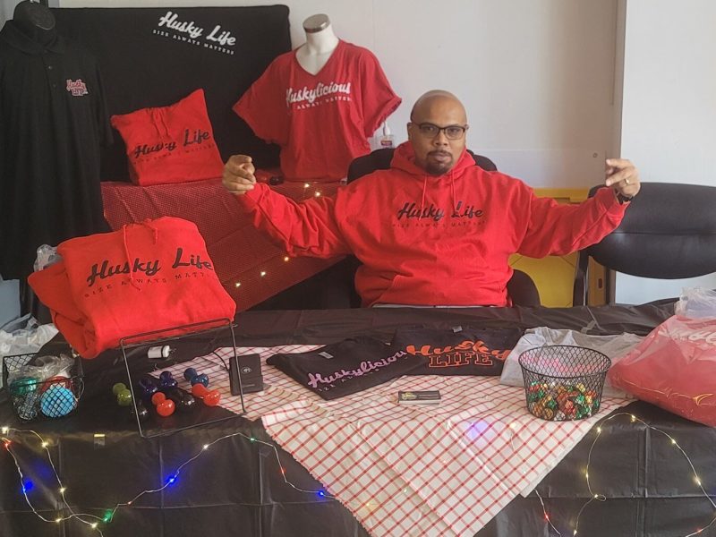 Gordon "Big" Dooley with merchandise from his clothing line, Husky Life. Free coaching from the Small Business Success program helped Dooley refine his business plan.
