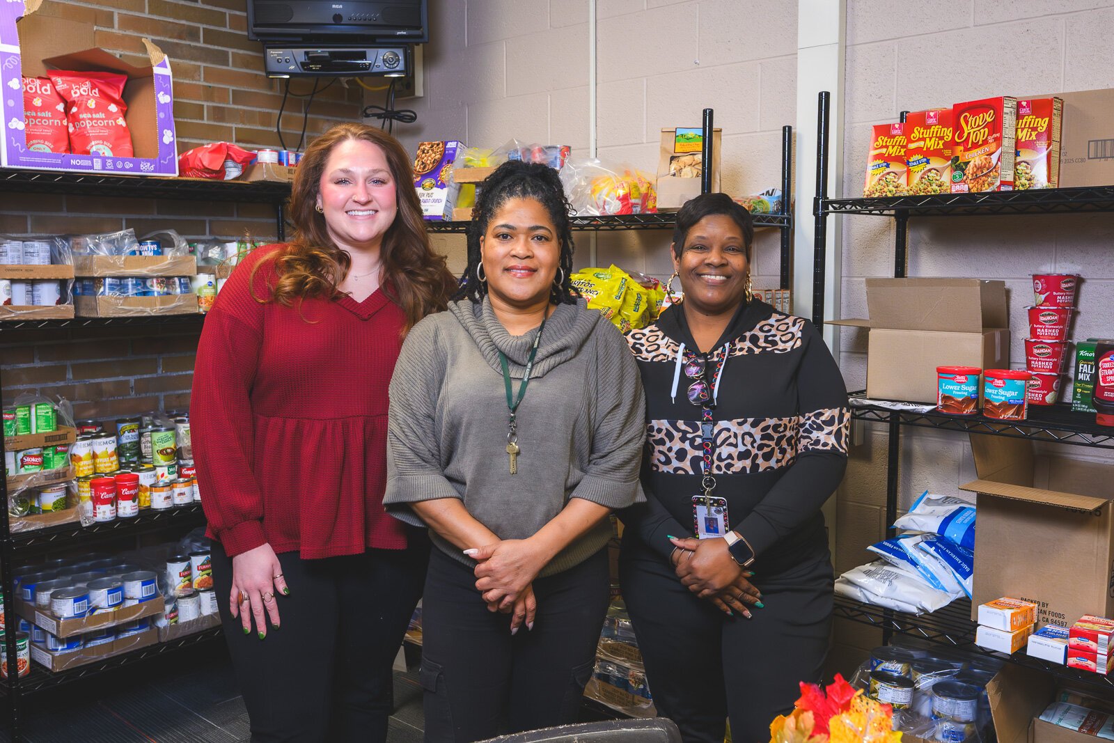 Assistant manager Lindsay Bohn, manager Tonysha Emerson, and assistant manager Sonya Rougeau at YCHS' food pantry.