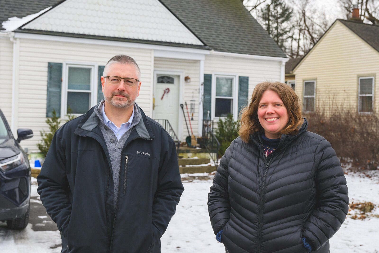 Luther Blackburn with Katelyn Zak in front of her home that had its lead service lines replaced by YCUA.