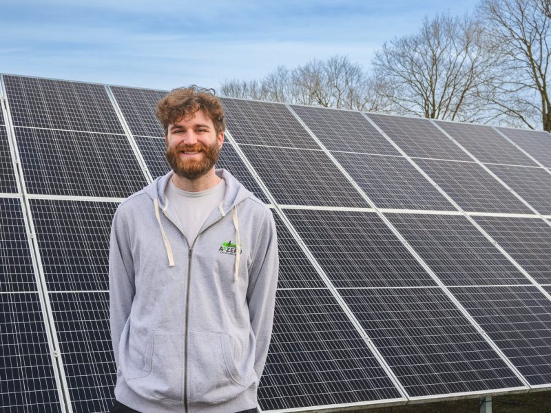Joe Lange by solar panels at Northside Community Center in Ann Arbor.
