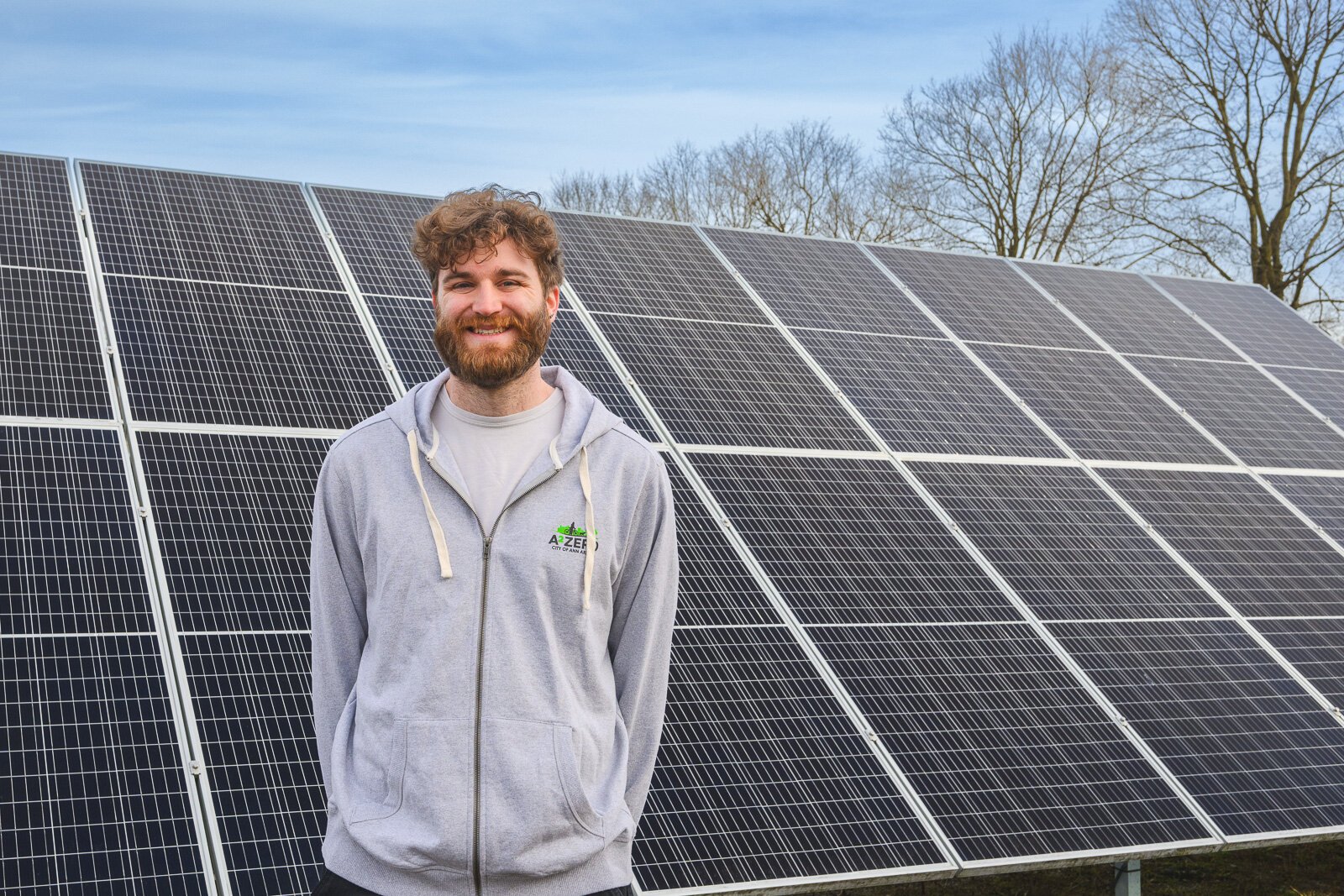 Joe Lange by solar panels at Northside Community Center in Ann Arbor.