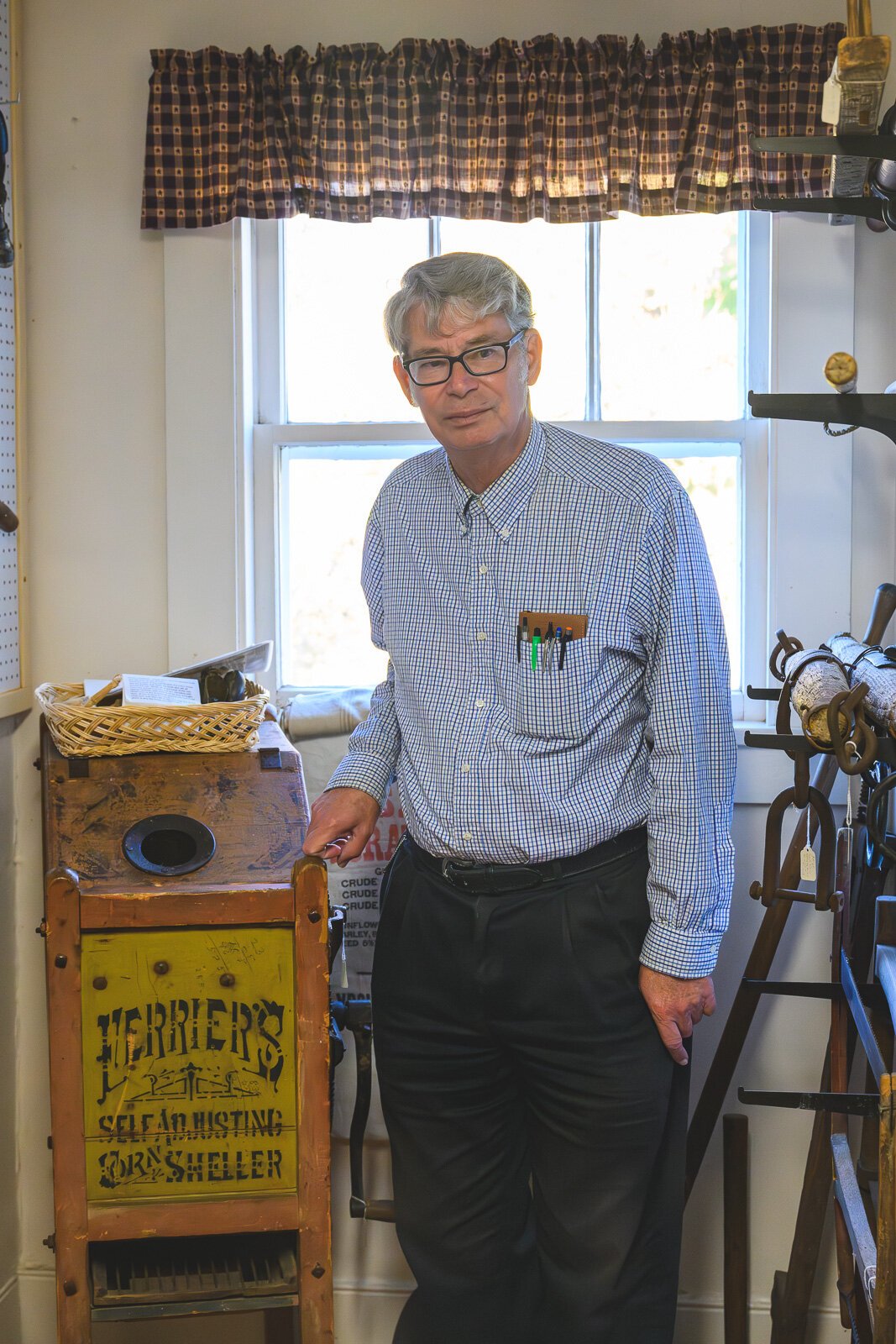 Ypsilanti Historical Society Museum and Archives archivist James Mann with an antique patented corn sheller from Ypsilanti.