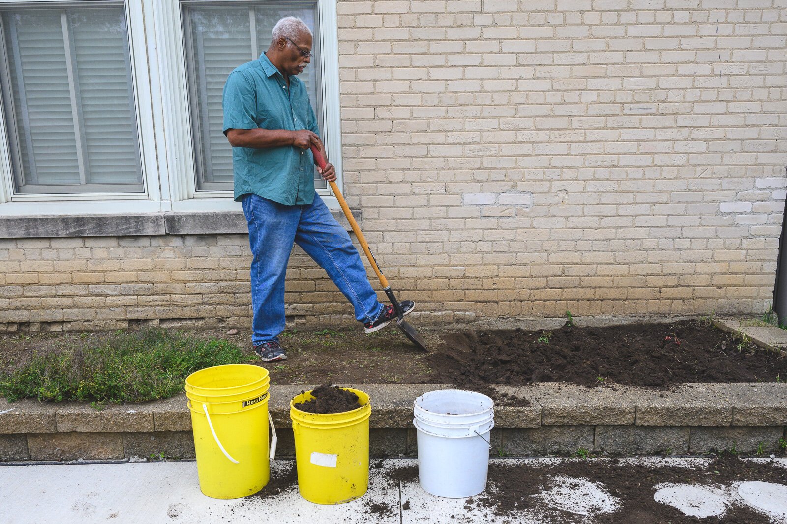 Roger Smith working on the gardens at Cross Street Village.