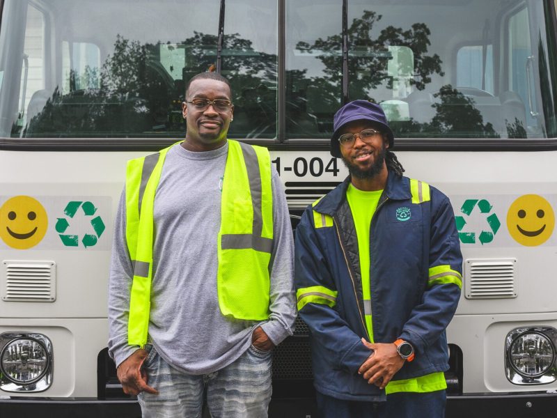Courtney Franklin and Greg Carter demonstrating a recycling truck at the Ann Arbor's Material Recycling Facility tour.
