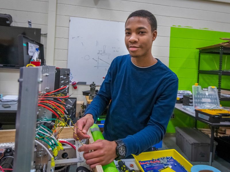 Austin McDonald works on a robot with Lincoln High School's Linc-Bots team in 2019.