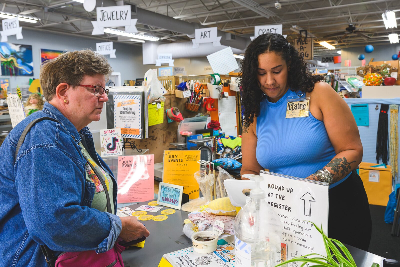 Claire Tyra (right) ringing up a customer at SCRAP Creative Reuse Ann Arbor.