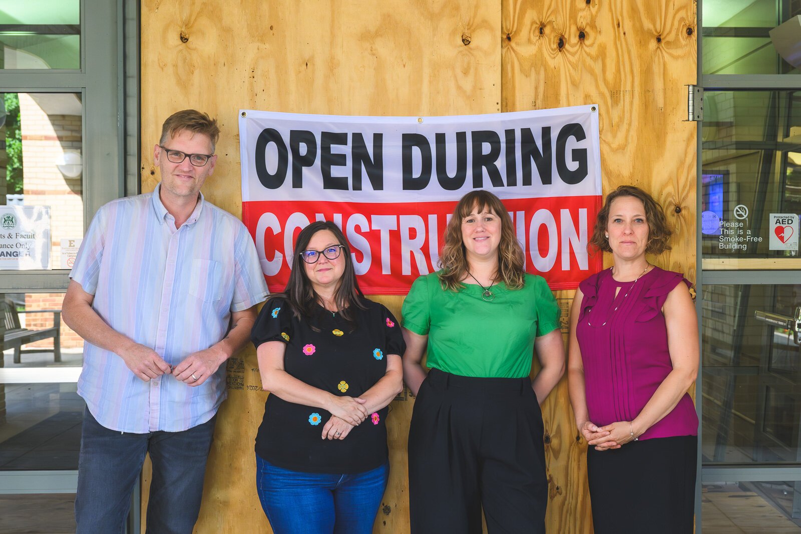 Matt Jones, Amber Davis, Brooke Boyst, and Alexis Braun Marks outside of Halle Library during the renovation.