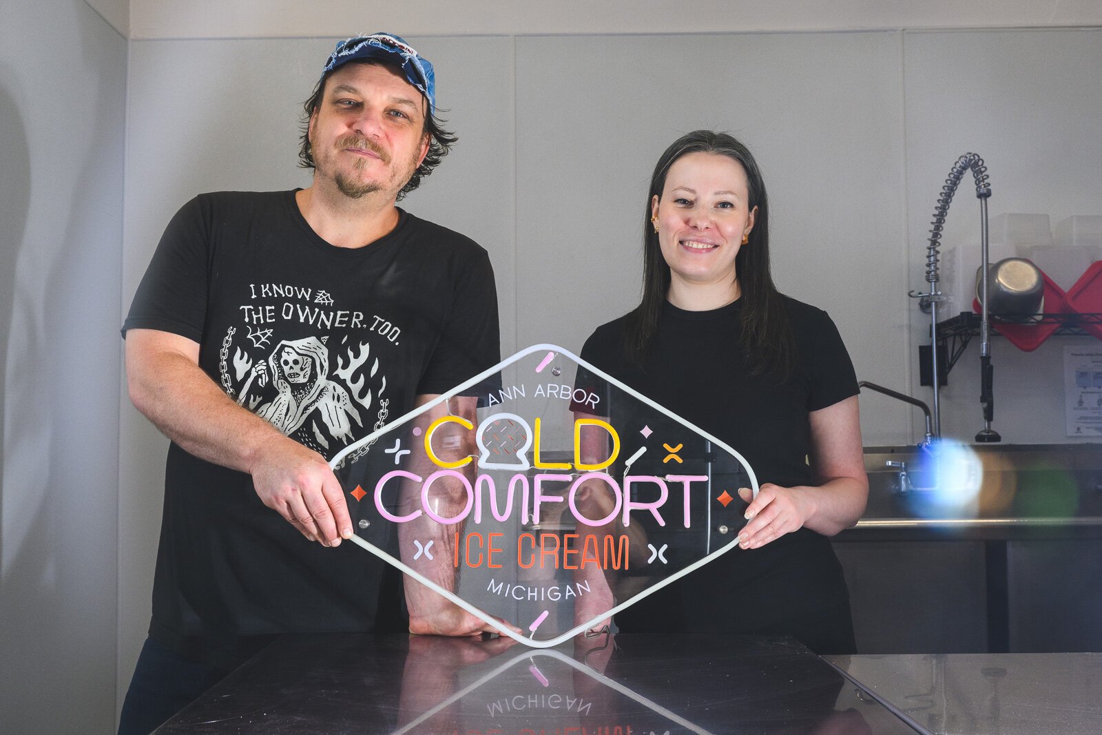 Cold Comfort Ice Cream onwers Eric Farrell and Danielle Berridge with their soon to be updated store sign.