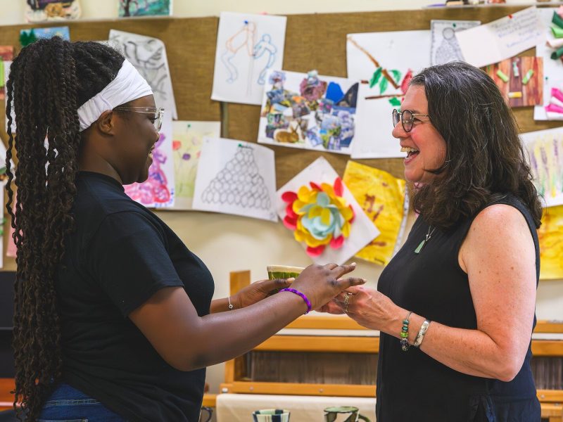 Kayla Davis being honored by Gail Wolkoff at the Educate Youth graduation celebration.