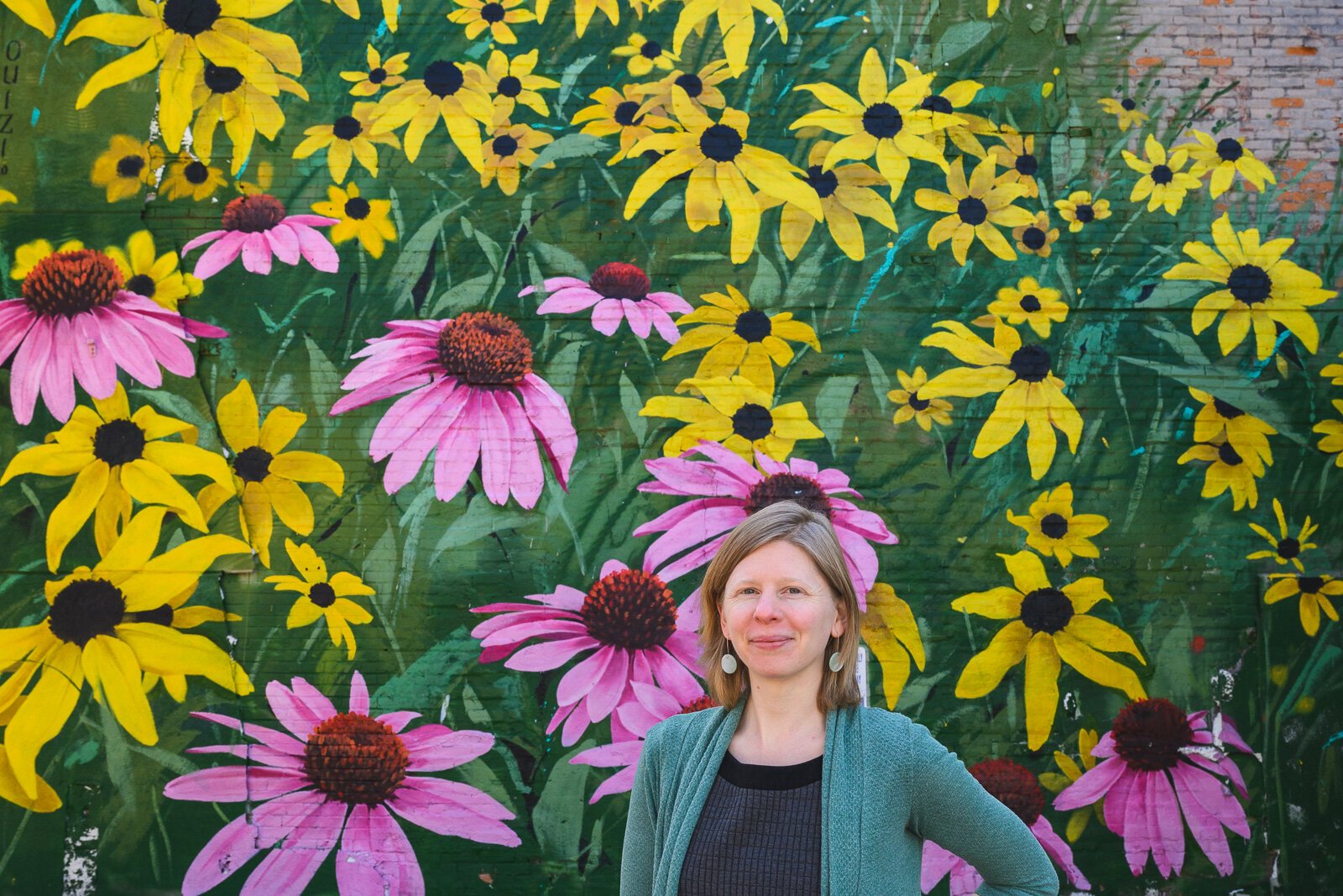 Hannah Kirkpatrick in front of Ouizi's "Drift" mural.