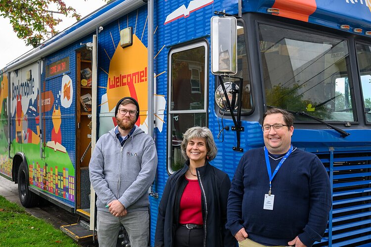 Aaron Smith, Lisa Hoenig, and Sam Killian at the bookmobile outside of the Ypsilanti District Library Michigan Avenue branch.
