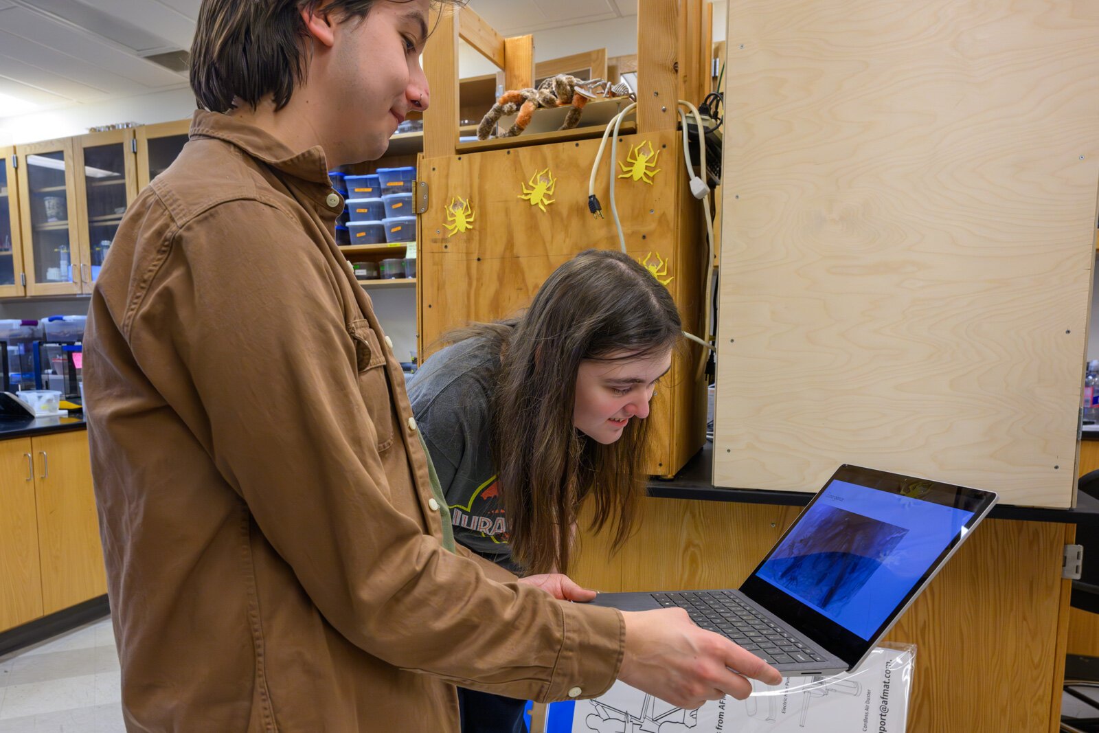 Bradley Allendorfer sharing a video from a tarantula burrow with Nicole Zuraw.