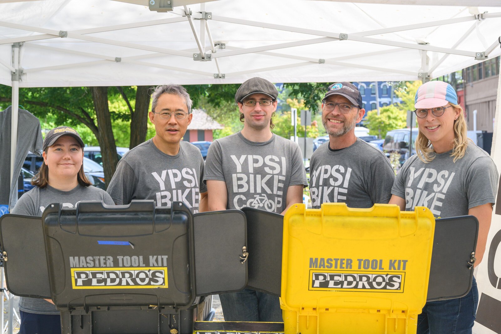 Emma Nelson, Yitah Wu, Anthony Lutz, Terry Carpenter, and Valerie Fox at the Ypsi Bike Co-op's booth at Ypsilanti's Depot Town farmers market.