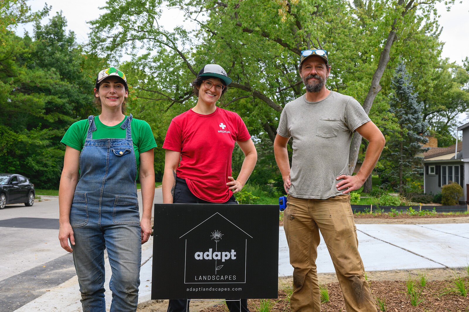 Kat Baskin, Rachel Lipson, and William Kirst of Adapt Landscapes planting a garden in Ann Arbor.
