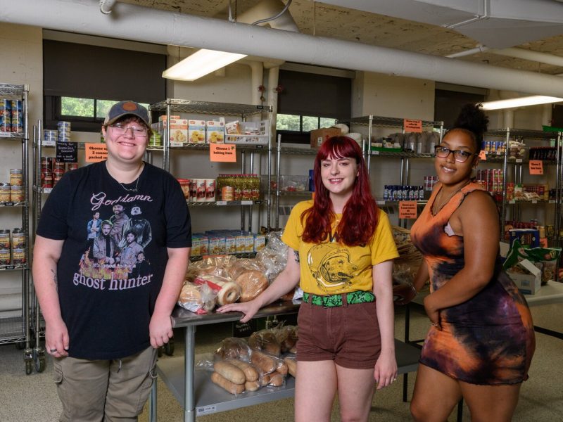 EMU students Ren Lands, Lauren Masserant, and Ruth Mella work at Swoop's Food Pantry.