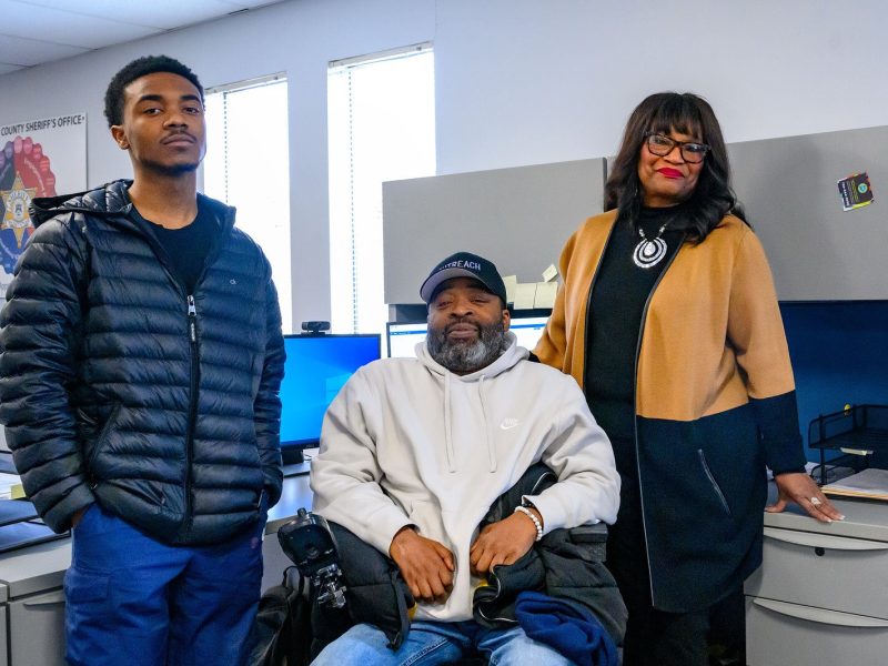 WeLIVE's Trevonte Thomas and Roger Roper with SURE Moms' Florence Roberson.