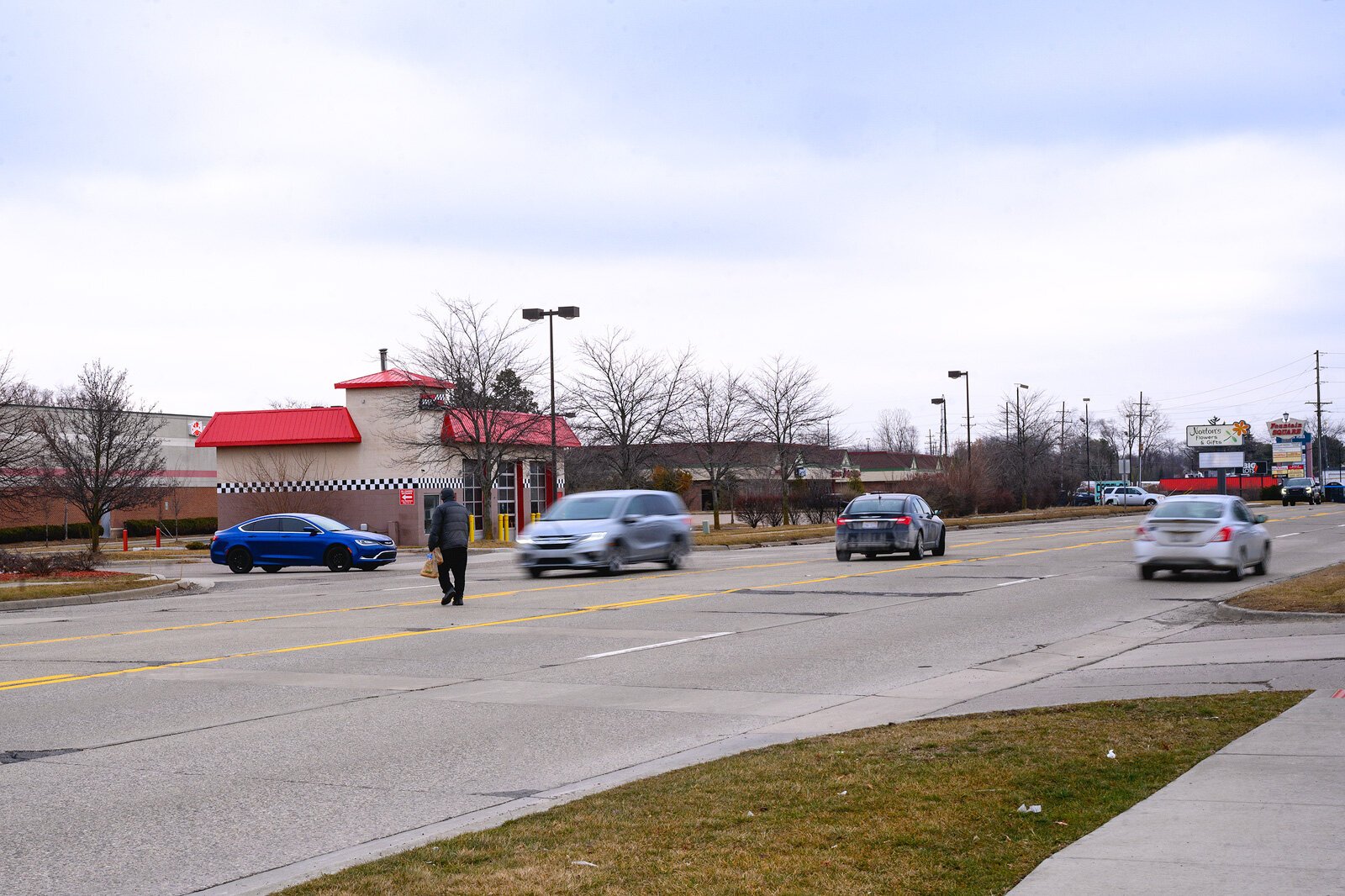 A pedestrian crossing Washtenaw Avenue.