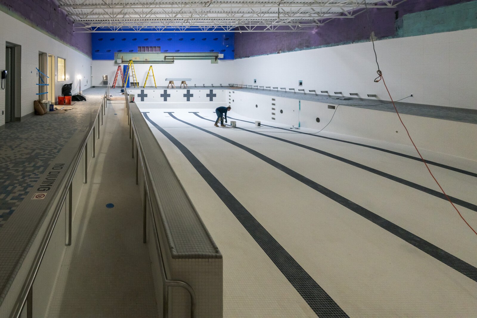 Finishing touches on the High Point School pool with a new ramp.