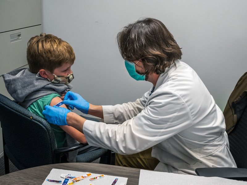 Alexander Lee recieves his COVID vaccine from Steve Jensen at Daycroft School.