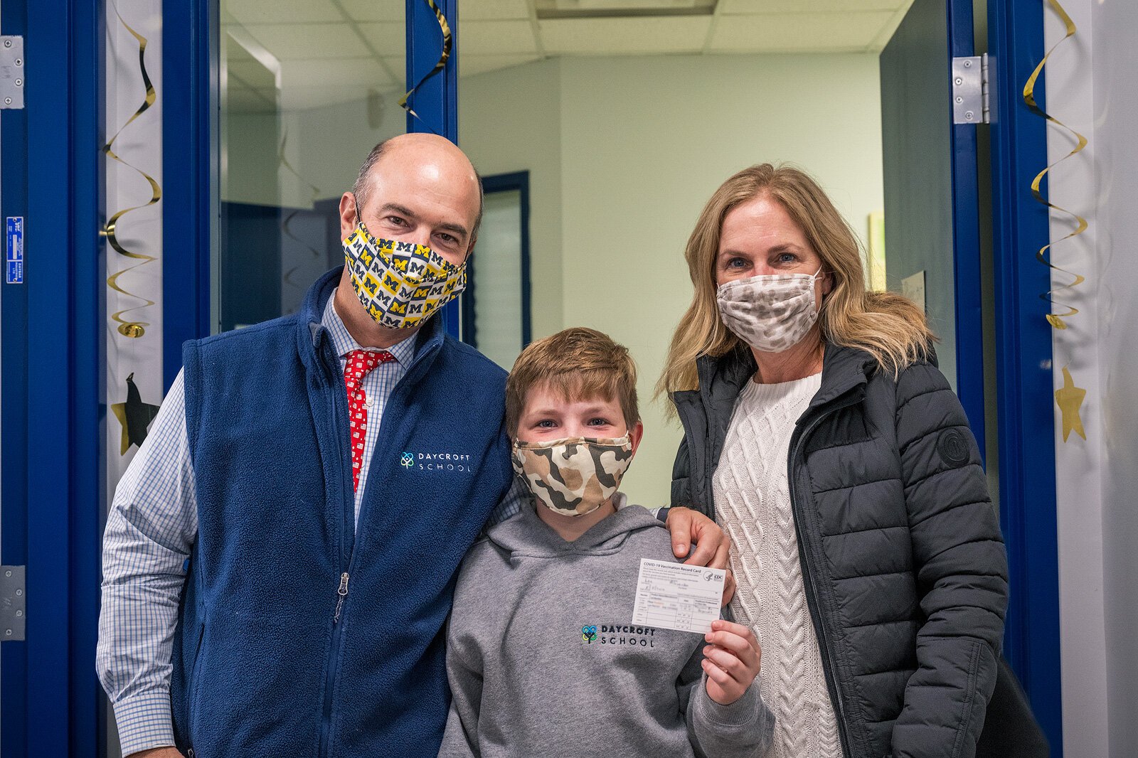Alexander Lee (center) with his parents David and Anglea Lee after receiving his vaccine at Daycroft School.