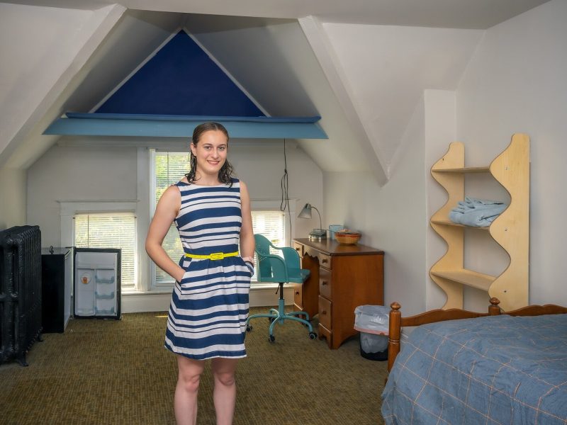 MOSAIC residence live-in program manager Anna DiGiovanni in a bedroom furninshed by HouseN2Home.