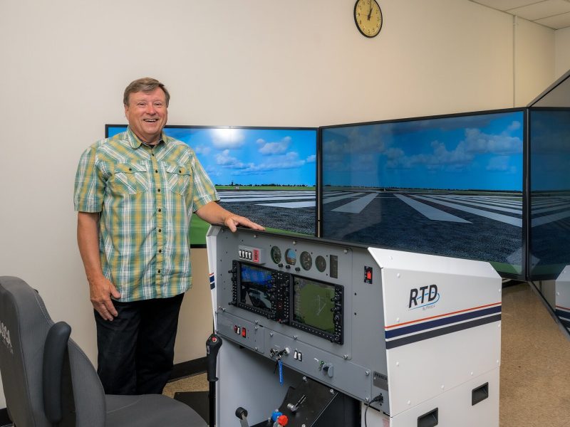 EMU aviation program coordinator Jerard Delaney with a new flight simulator.