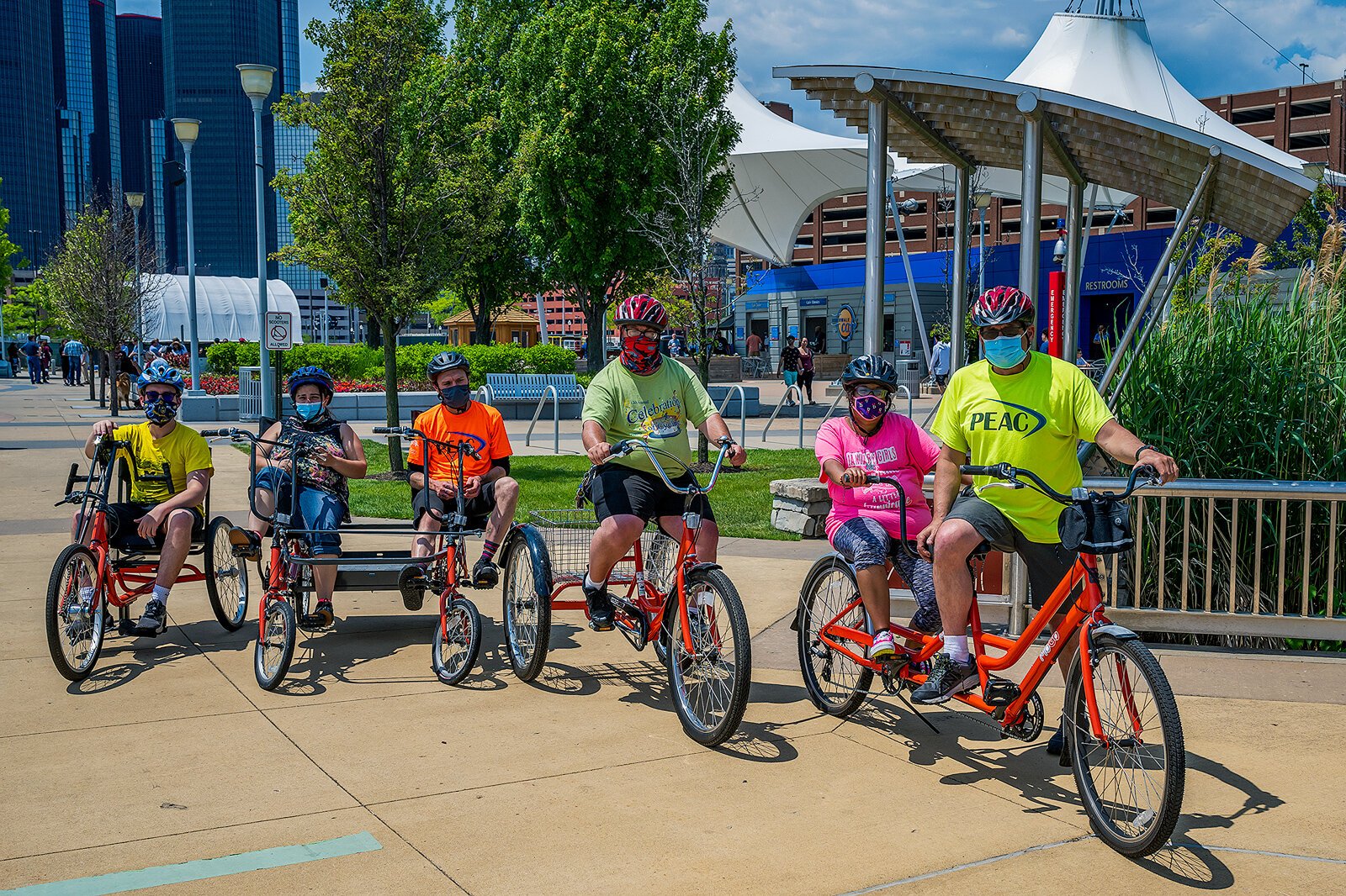 PEAC students Conor Waterman, Amanda Salinas, Owen Conley, Shawn Kohsmann, Tiara Sims, and PEAC founder John Waterman with MoGo adaptive cycles on the Detroit Riverwalk. 