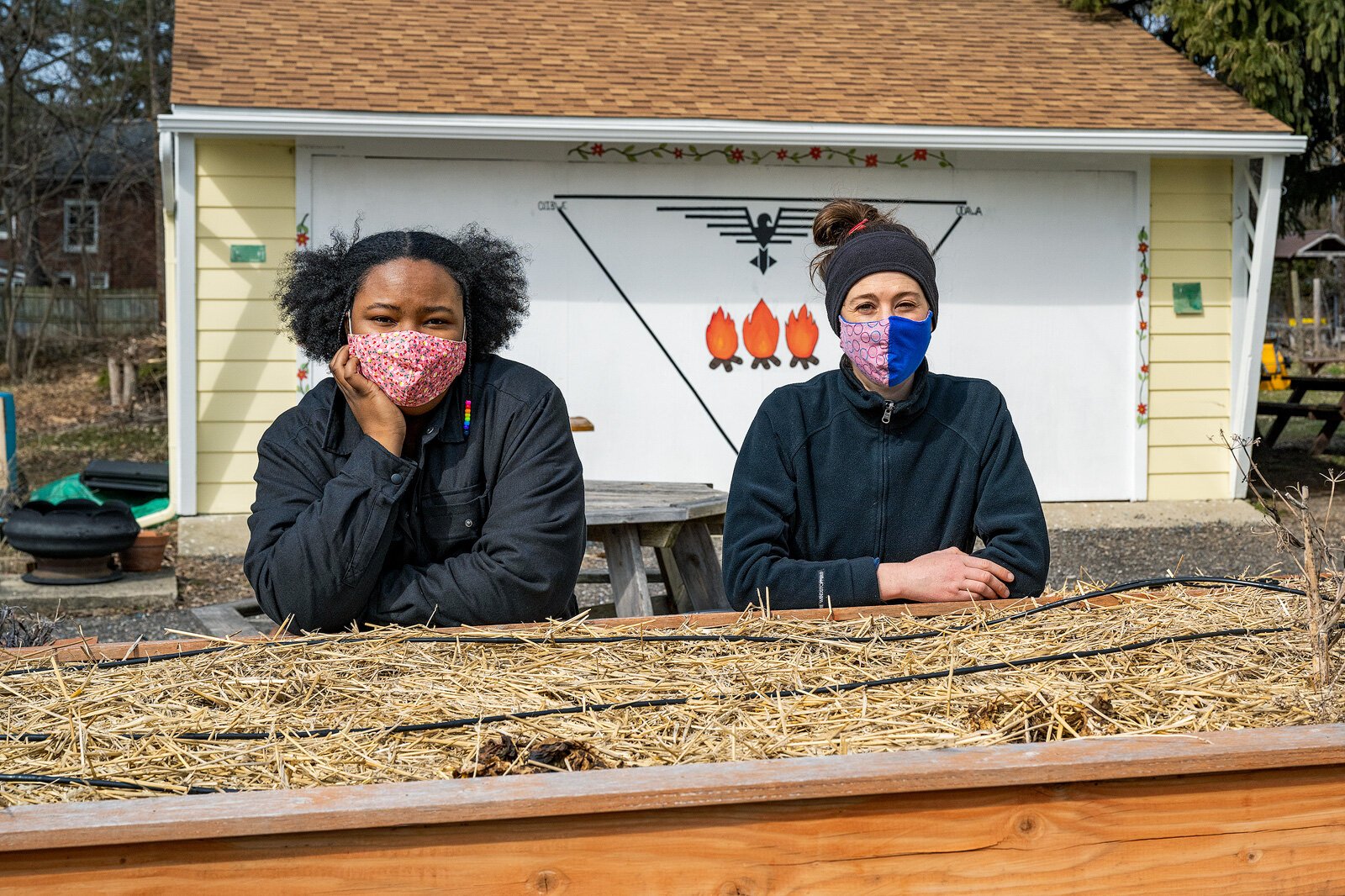 Home vegetable coordinator Teria Moore-Berry and Urban Farm Coordinator Charlotte Thurston by Growing Hope's wheel chair-accessible raised beds.